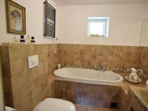 a bathroom with a tub and a toilet at Holiday home in an idyllic location in Debki in Dębki