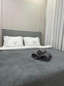 a bedroom with a bed with towels on it at ЖК - 4 YOU - Nomaden- 3 in Almaty