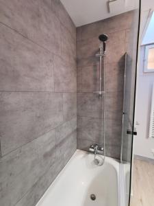 Das Bad ist mit einer Dusche und einer Badewanne ausgestattet. in der Unterkunft Appartement centre ville, parking gratuit in La Rochefoucauld