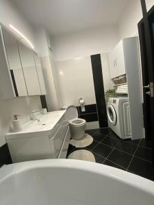 a small bathroom with a sink and a toilet at Dem ‘LuxuryApartmens in Râmnicu Vâlcea