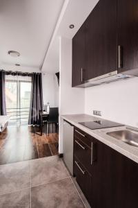 a kitchen with a sink and a counter top at Rezerwat85 in Gdańsk