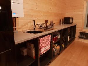 a kitchen with a sink and a counter top at Caban Cwtch - Log fire, pool table, hot tub cinema in Kent