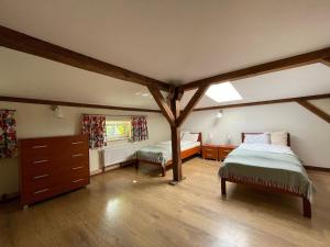 a bedroom with two beds and a dresser in it at Pokoje u świętego Krzysztofa in Wrocław