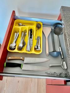 a tool box with utensils in it at Poilsis Vanagupėje in Palanga