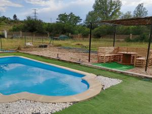 a swimming pool in a yard with a pavilion at Finca Arroyo del Valle in San Andrés del Rabanedo