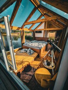 a wooden boat with a bed and a desk at Million star hotel Latgale in Nastrova