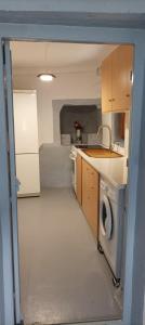 a kitchen with a sink and a washing machine at Paradise in Kollimpithra