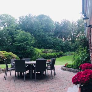 a table and chairs on a brick patio at 300m2 entire house with 3 bedrooms in Tistrup