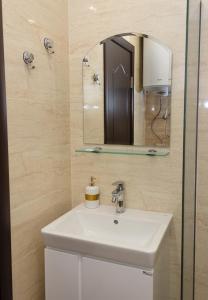 a bathroom with a white sink and a mirror at Golden Sands 1BD Apartment by Flat Mаnager in Varna City