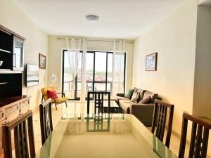 a living room with a glass table and a couch at Galileo Rooms in Il- Gżira