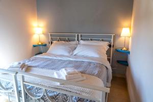 um pequeno quarto com uma cama com 2 candeeiros em Villa Fenice Country House em Borgo a Mozzano