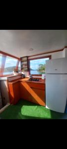 a kitchen with a counter and a refrigerator in a boat at Yakamoz A in Marmaris