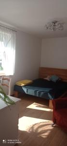 um quarto com uma cama e uma janela em Oaza Miłości em Lipniki