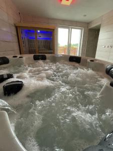 a large tub filled with water in a bathroom at Chalupa Soběšice - kraj Šumavy in Soběšice