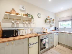 a kitchen with a counter top with a microwave at The Stables Cottage in Hemingby