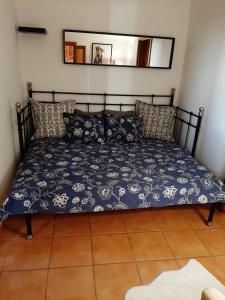 a bed with a blue bedspread and pillows on it at La Barrica in Soo