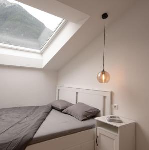 a bedroom with a bed and a skylight at Casa Pina Campo Tures in Campo Tures