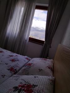 a bedroom with two beds and a window at Nice view-Plitvice in Korenica