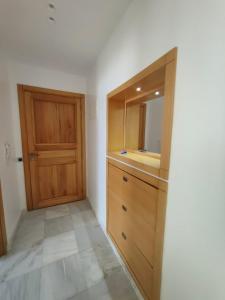a bathroom with a wooden cabinet and a mirror at Appartement meublé sala al jadida in Oulad Yakoub