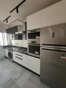 a kitchen with a stove and a stove top oven at Appartement meublé sala al jadida in Oulad Yakoub