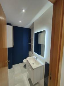 a bathroom with a white sink and a toilet at Appartement meublé sala al jadida in Oulad Yakoub