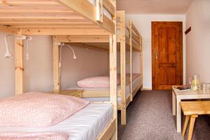 A bed or beds in a room at Chata pod Sedlom Čertovica