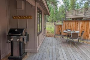 a patio with a grill and a table on a house at 18 Deer Lane in Sunriver