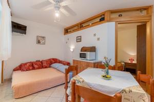 a living room with a table and a couch at Kovacine apartment in Cres