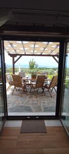 a view of a patio with a table and chairs at NOCE Luxury Villas Resort in Vourvourou