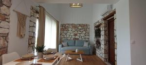 a living room with a blue couch and a table at NOCE Luxury Villas Resort in Vourvourou