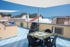 um pátio com uma mesa e cadeiras no telhado em Casa Zu Peppino em Lipari