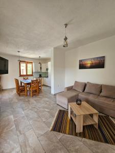 a living room with a couch and a table at Holiday homes Sintija in Rab +92 photos