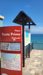 un cartel en un paseo junto al océano en Apartamento Sultan, Punta Prima, Panorama Park, 2 bed & 2 beautiful swimming pools, en Punta Prima