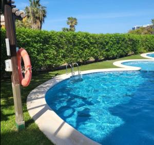 una piscina con un tobogán en el césped en Apartamento Sultan, Punta Prima, Panorama Park, 2 bed & 2 beautiful swimming pools, en Punta Prima