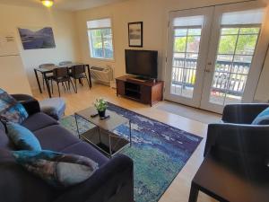 a living room with a couch and a tv at Hood River Suites Extended Stay Apartment Hotel in Hood River