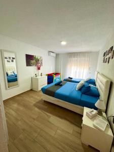 a bedroom with a large blue bed in a room at Boutique Apartment by the Sea in Alicante