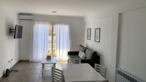 a living room with a couch and a table at Las Acacias Tandil in Tandil
