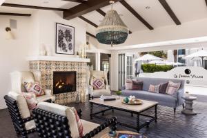 a living room with couches and a fireplace at La Serena Villas, A Kirkwood Collection Hotel in Palm Springs
