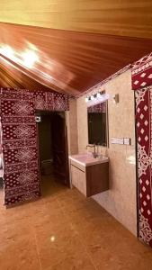 a bathroom with a sink and a mirror at Al Rifi Luxury Camp in Wadi Rum