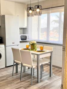 a kitchen with a white table and chairs at Stay In Madeira in Funchal