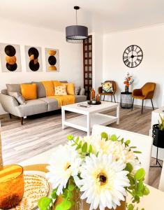 a living room with a couch and a table with flowers at Stay In Madeira in Funchal