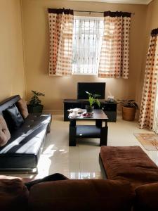 a living room with a couch and a coffee table at Just Chill Villa in Trou aux Biches