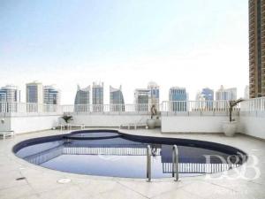 a swimming pool on the roof of a building at Amazing View I 1min Walk to Marina Mall I Close to Beach in Dubai