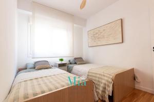 Postel nebo postele na pokoji v ubytování City and Beach Apartment