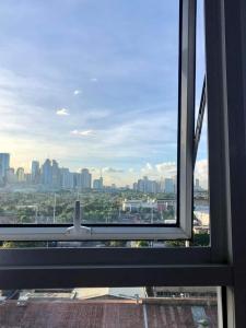 a view of a city from an office window at Kasara Urban Resort and Residences in Manila