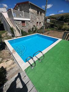 a swimming pool in front of a house at Casa do Canto in Macedo de Cavaleiros