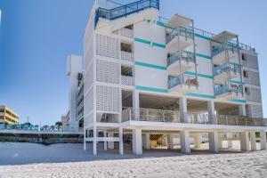 aominium building on the beach with a beach at Fontainebleau Terrace 223 in Panama City Beach