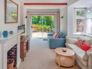 a living room with a couch and a fireplace at Framingham in South Hayling