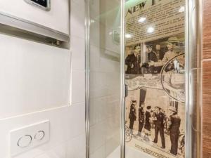 a glass door in a kitchen with a poster on the wall at Blue Apartment Gdańsk in Gdańsk