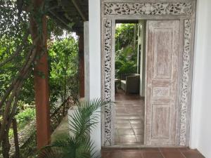 an open door to a house with a garden at Bangsring Breeze in Banyuwangi